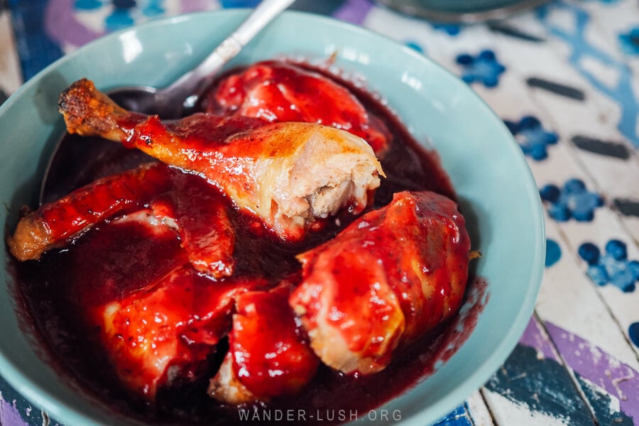 Chicken in blackberry sauce, a vibrant dish from Imeretian cuisine served at a restaurant in Argveta, Georgia.