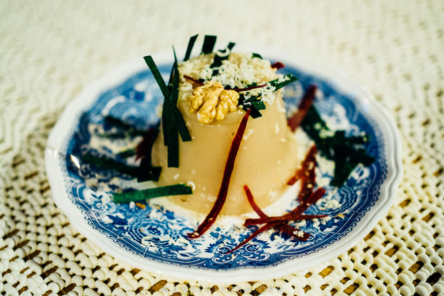 A jelly-like dessert on a blue and white dish.