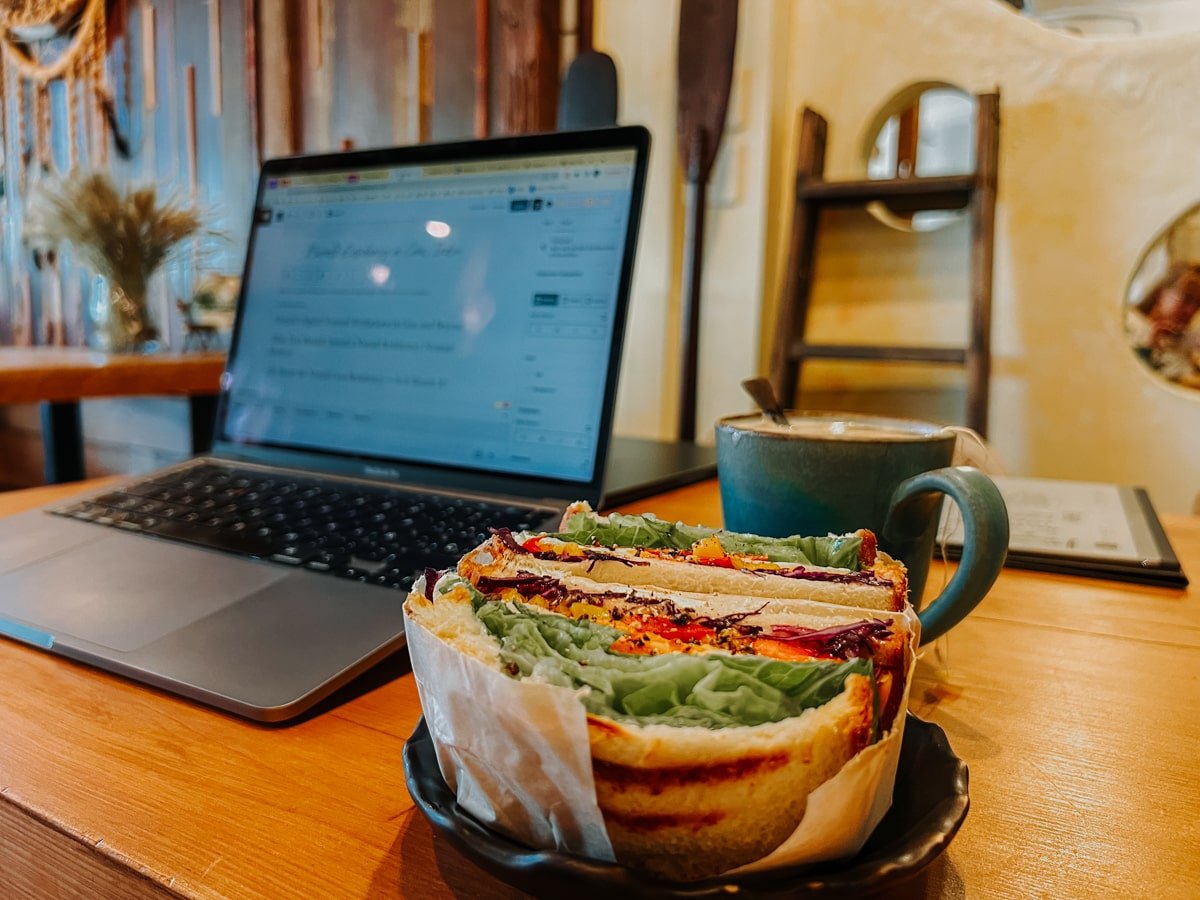 Sandwich, chai latte, and laptop on table at Seedson Cafe in Hualien City, Taiwan.