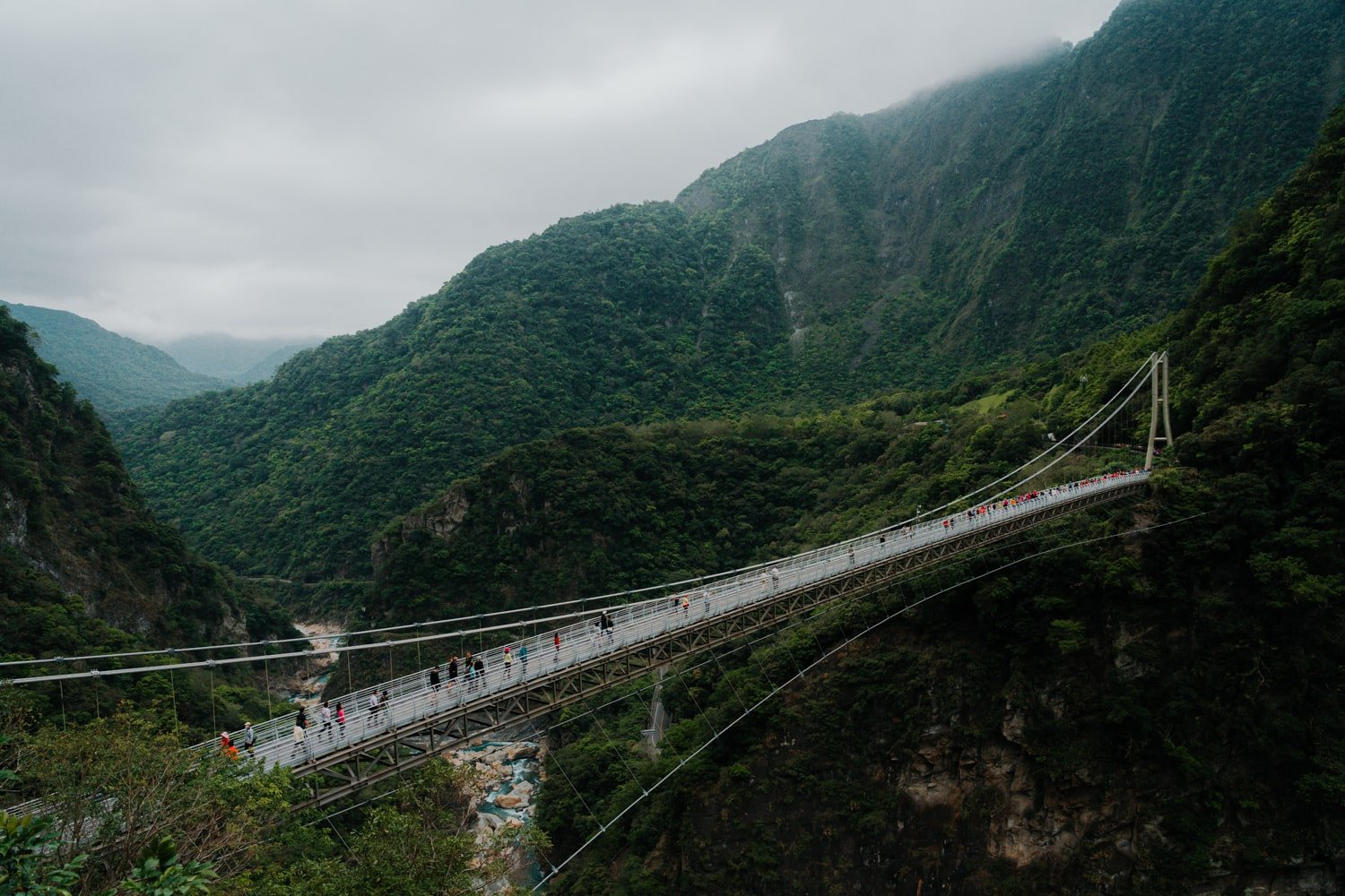 Tourists crossing the Buluowan Suspension Bridge inside Taroko Gorge, Taiwan.