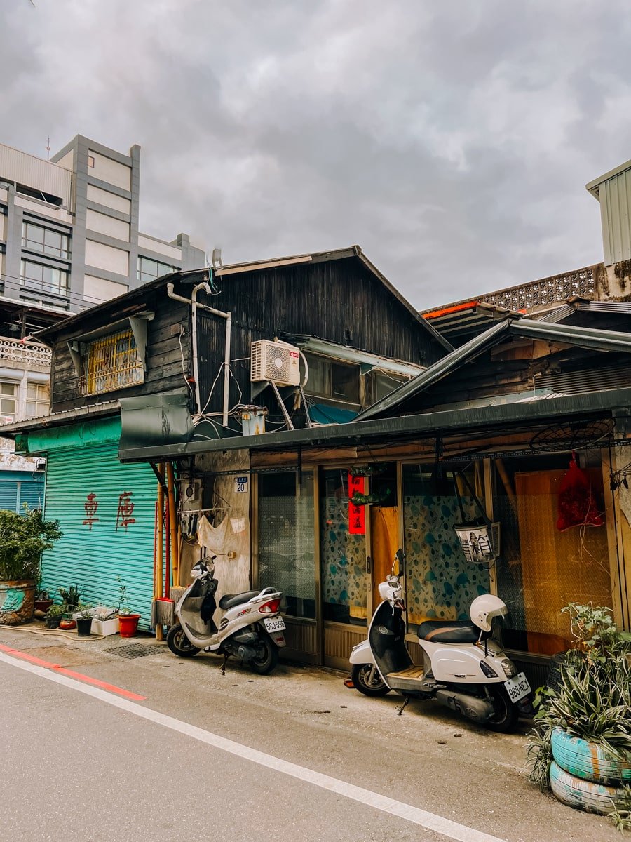 Traditional style Taiwanese house with scooters parked out front in the streets of Hualien City, Taiwan.