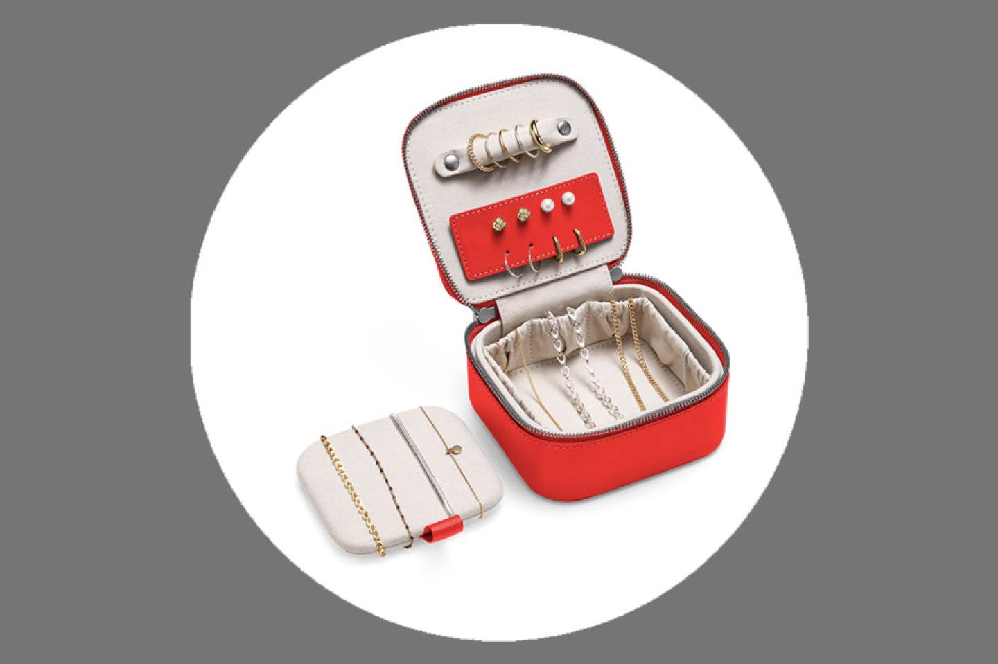 Square red travel jewelry case open with a few silver items