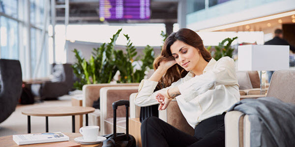 female who pays taxes for expats in an airport checking if she passes the bona fide residency test