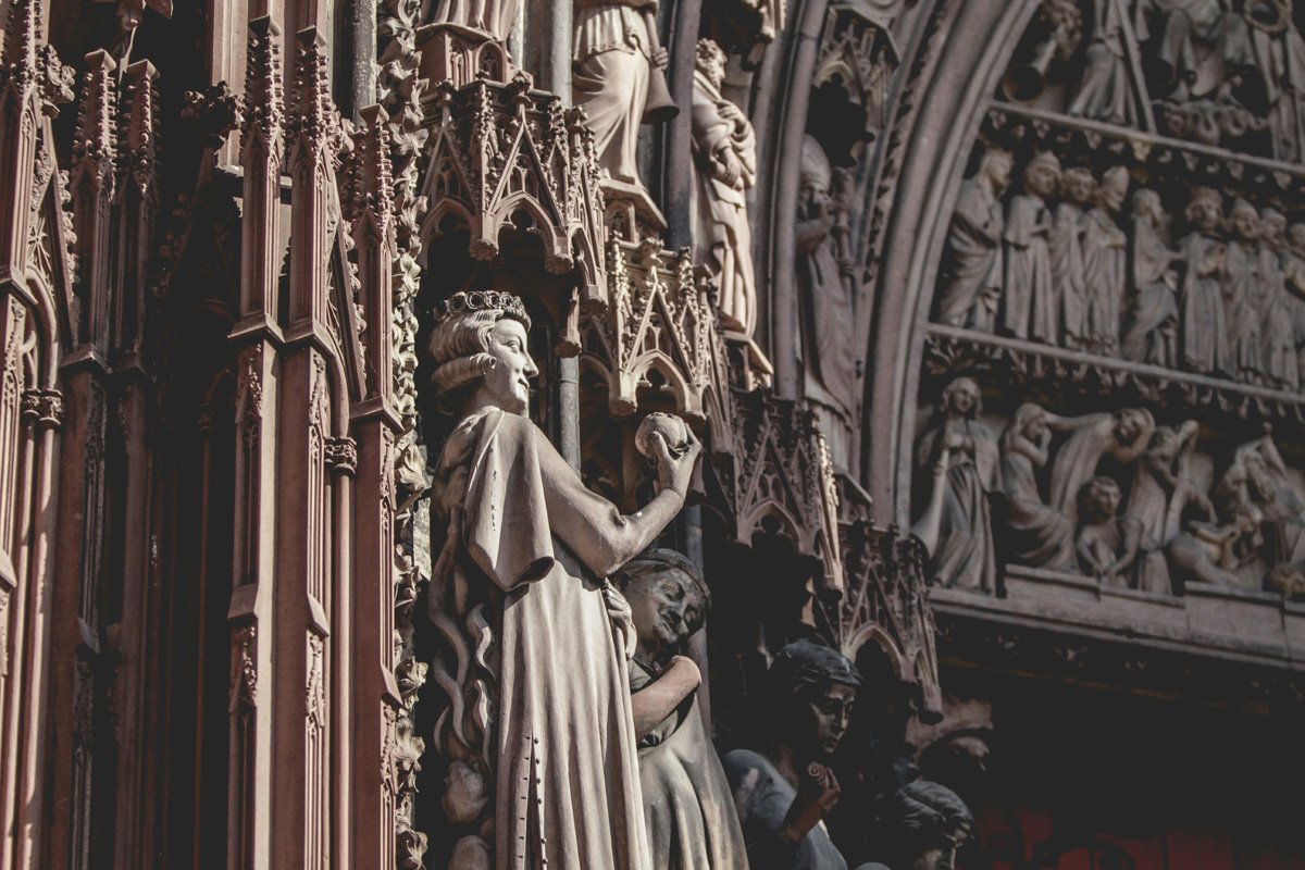 A detail of the ornate facade of the cathedral in Strasbourg showing figures and apostles. 