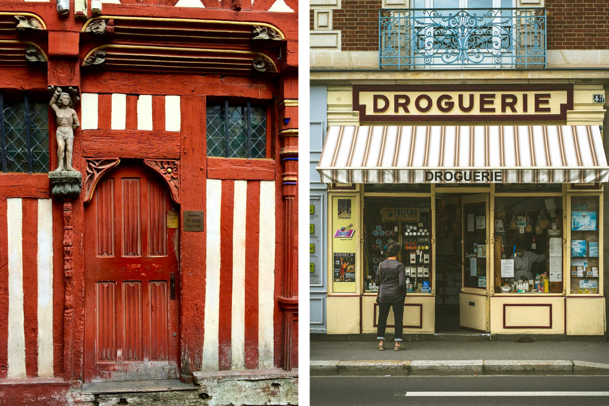 A brightly red half-timbered home next to a pastel yellow shop.