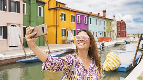 Francesco Vaninetti Photo/Getty Images Woman taking a selfie in Burano, Venice