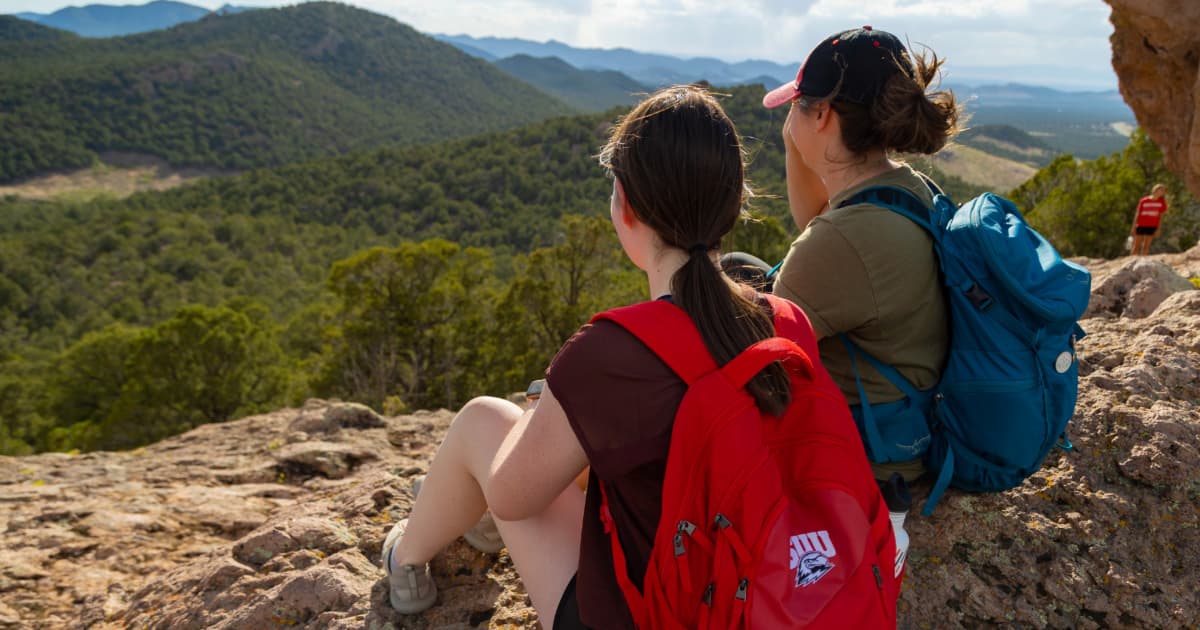 College students on a hike looking at a beautiful view.