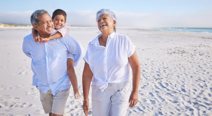 A couple retiring on $5 million and enjoying the beach with their grandson