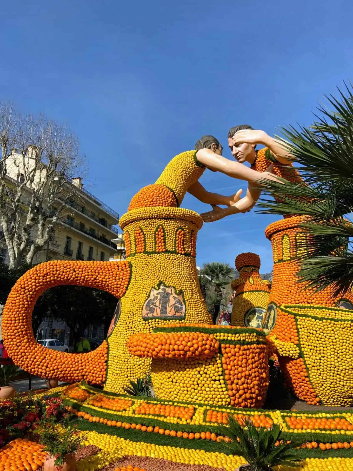 Lemon sculpture of two men wrestling in Ancient Greek vases at the Menton lemon festival