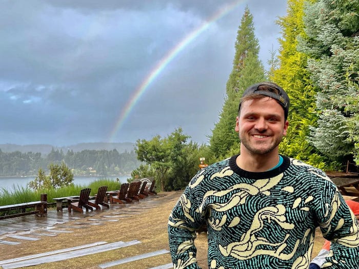 Evan Lambert in front of a rainbow in Bariloche, Argentina.