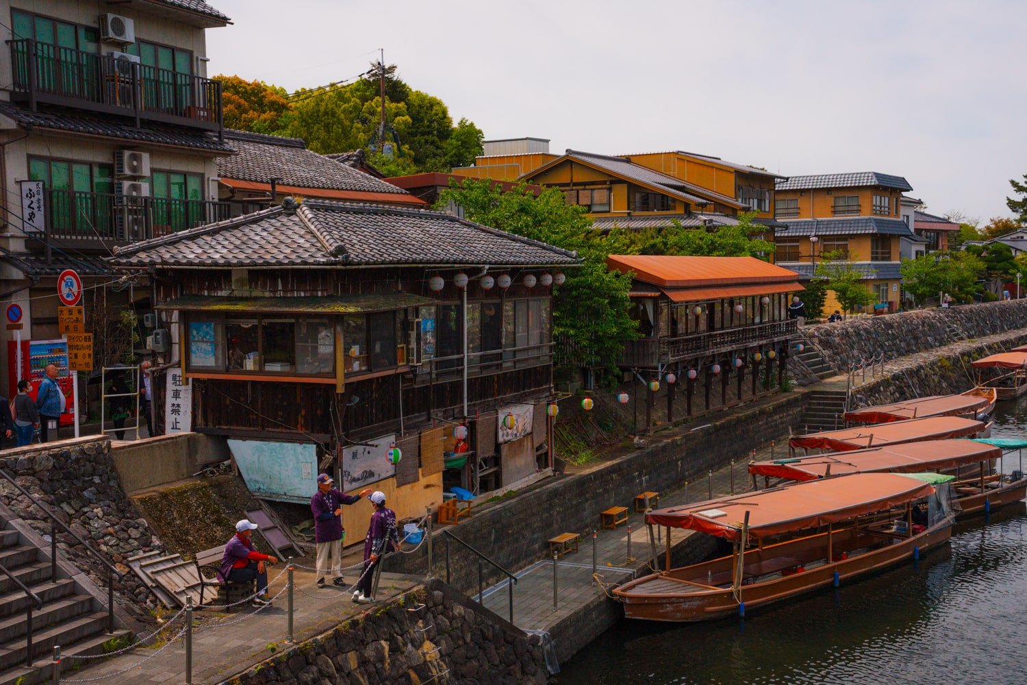 Local scene of traditional boats and lanterns along the river in Uji, Japan.