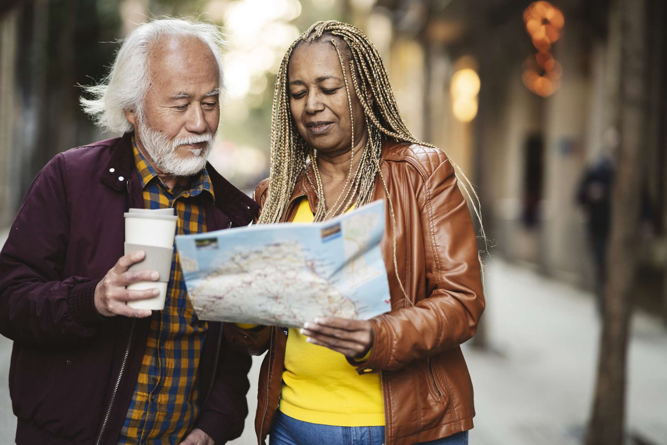 Two people looking at a map on a city street.