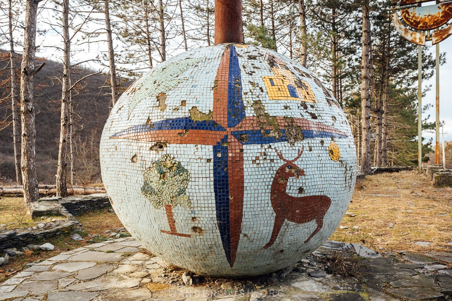 A mosaic globe with deer and tree emblems marks the entrance to Tianeti Municipality in Georgia.