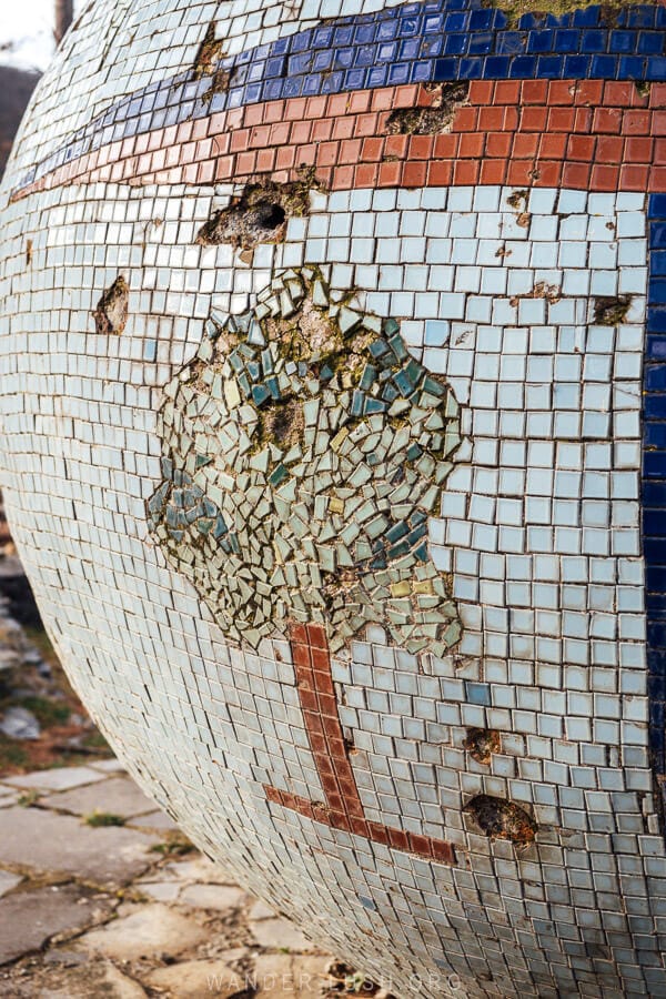 Details of a mosaic globe with deer and tree emblems that marks the entrance to Tianeti Municipality in Georgia.