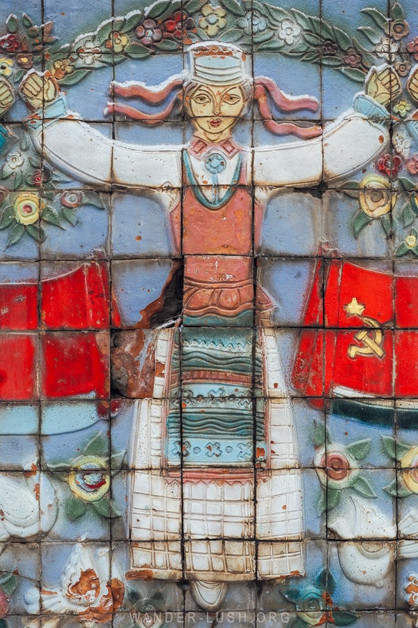 A Soviet-era mosaic depicting a woman in traditional dress on the road to Sabaduri in Georgia.