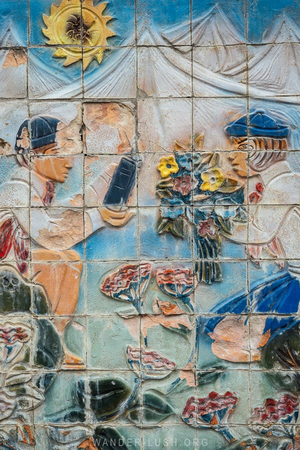 A mosaic near a former Young Pioneer Camp shows two children with a bunch of flowers.