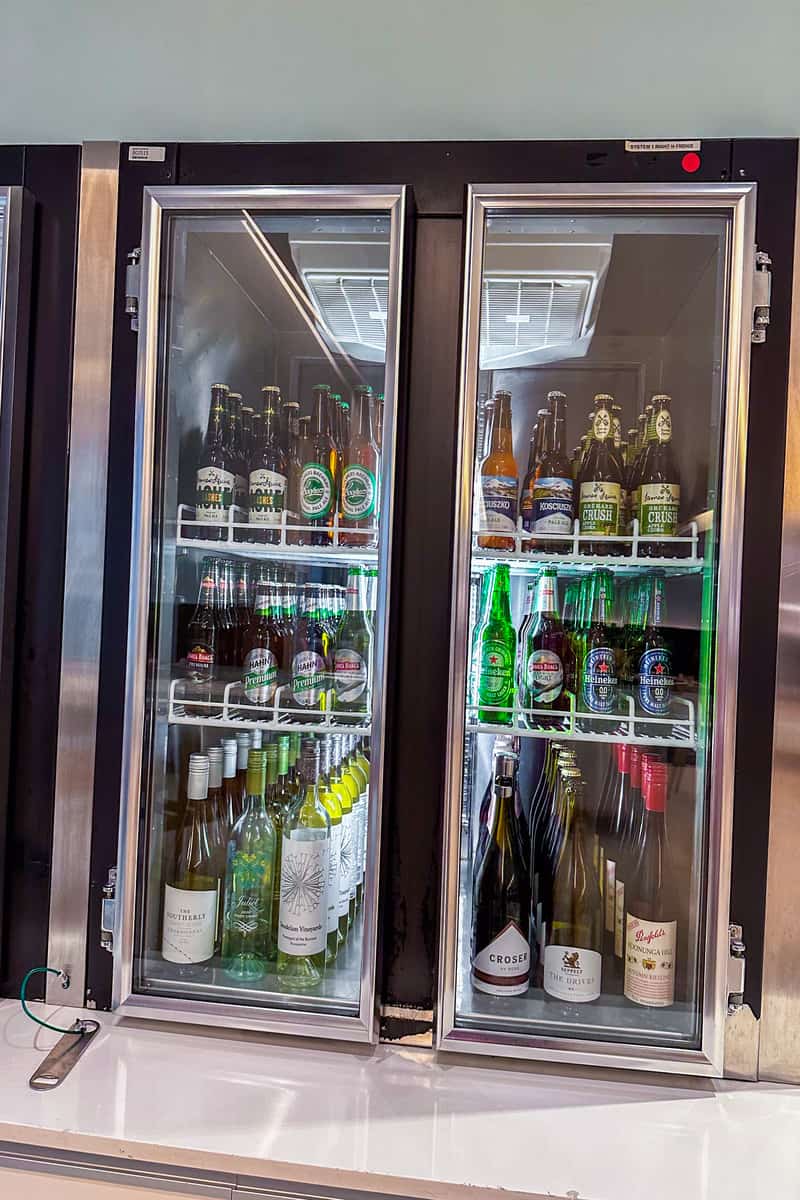 Fridge full of refrigerated bottles, including wine