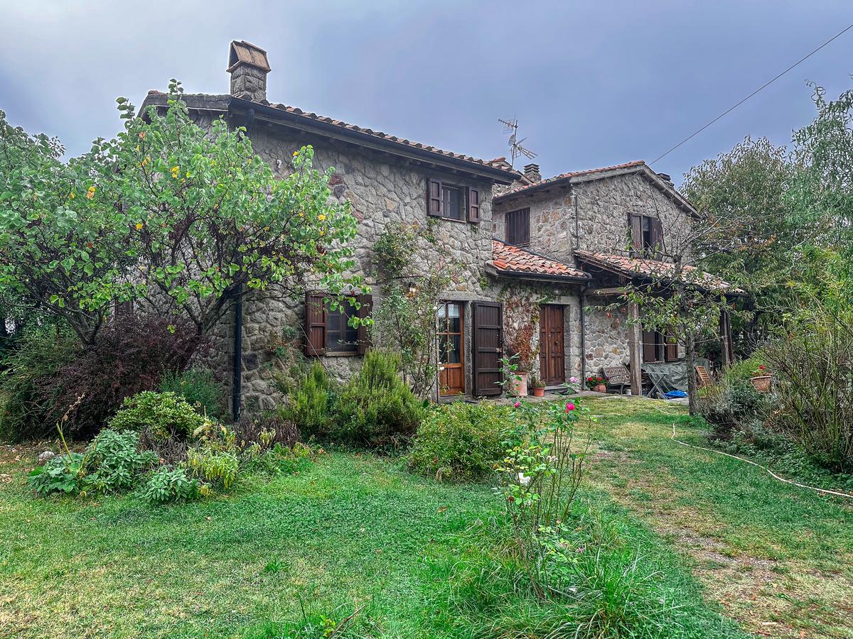 Rustic stone villa surrounded by lush gardens in Tuscany