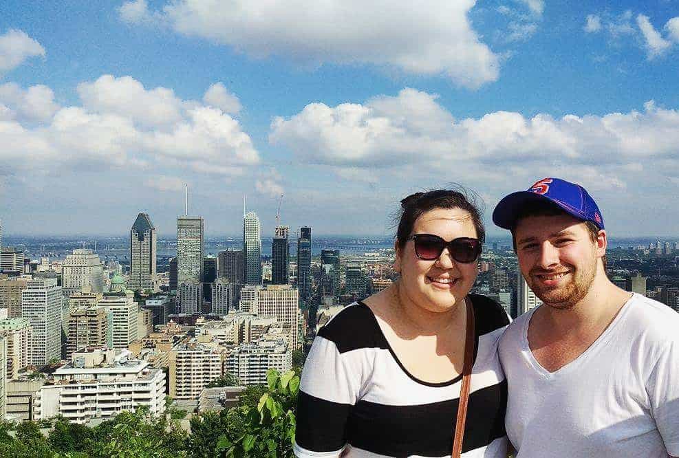 Colin and Riana posing at the top of Mount Royal, Montreal, Quebec overlooking downtown Montreal on a cross Canada trip