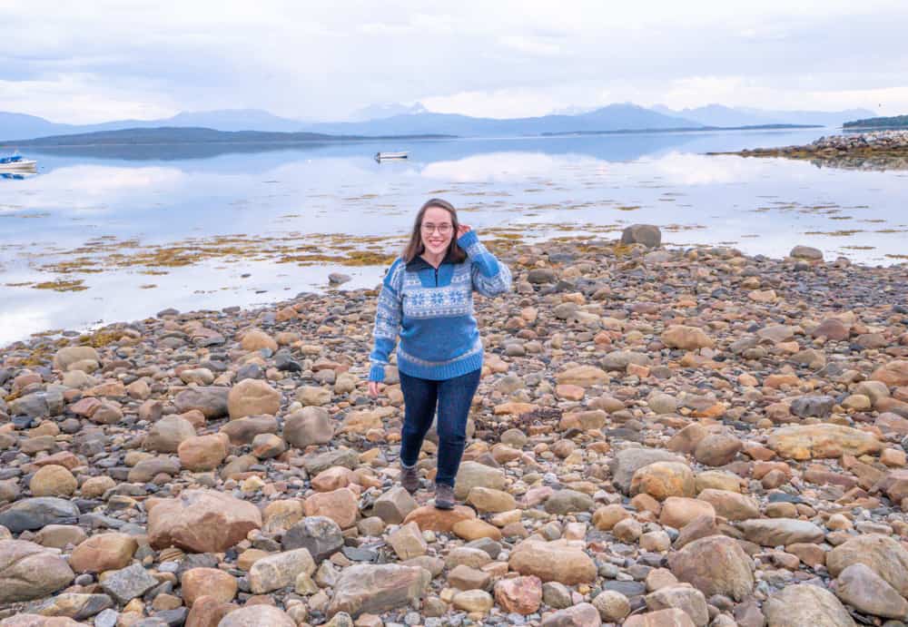 Jessica walking on rocks by the water