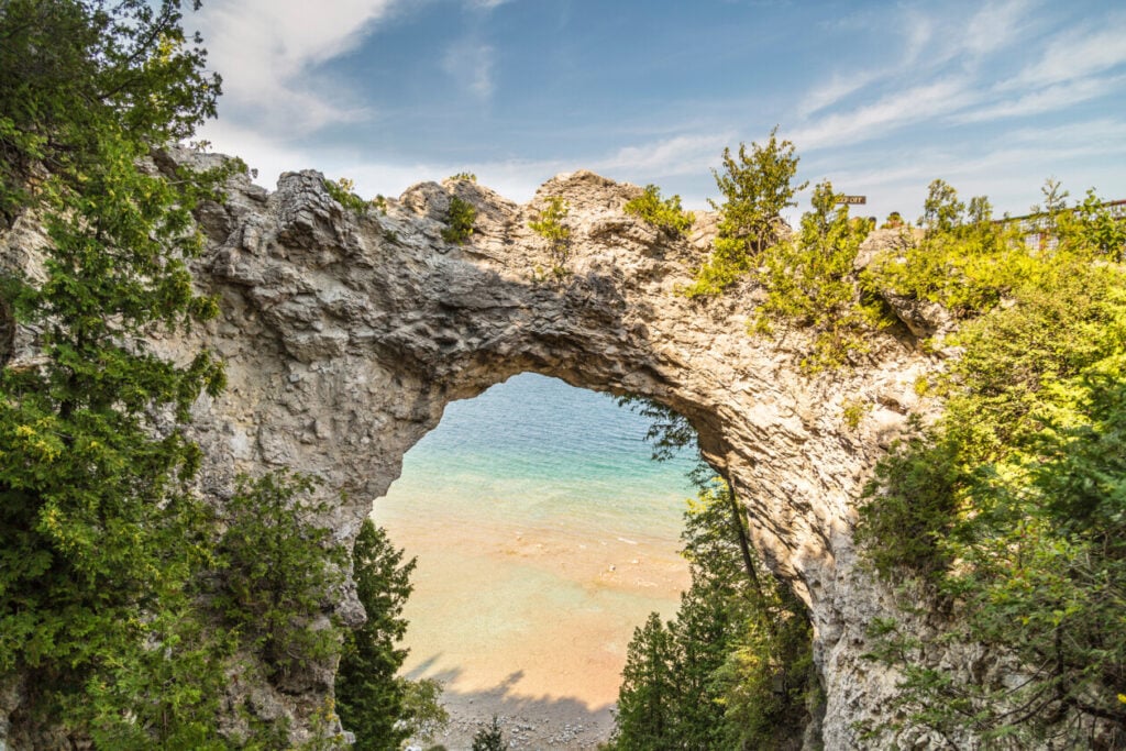 a rocky archway and beach on mackinac island