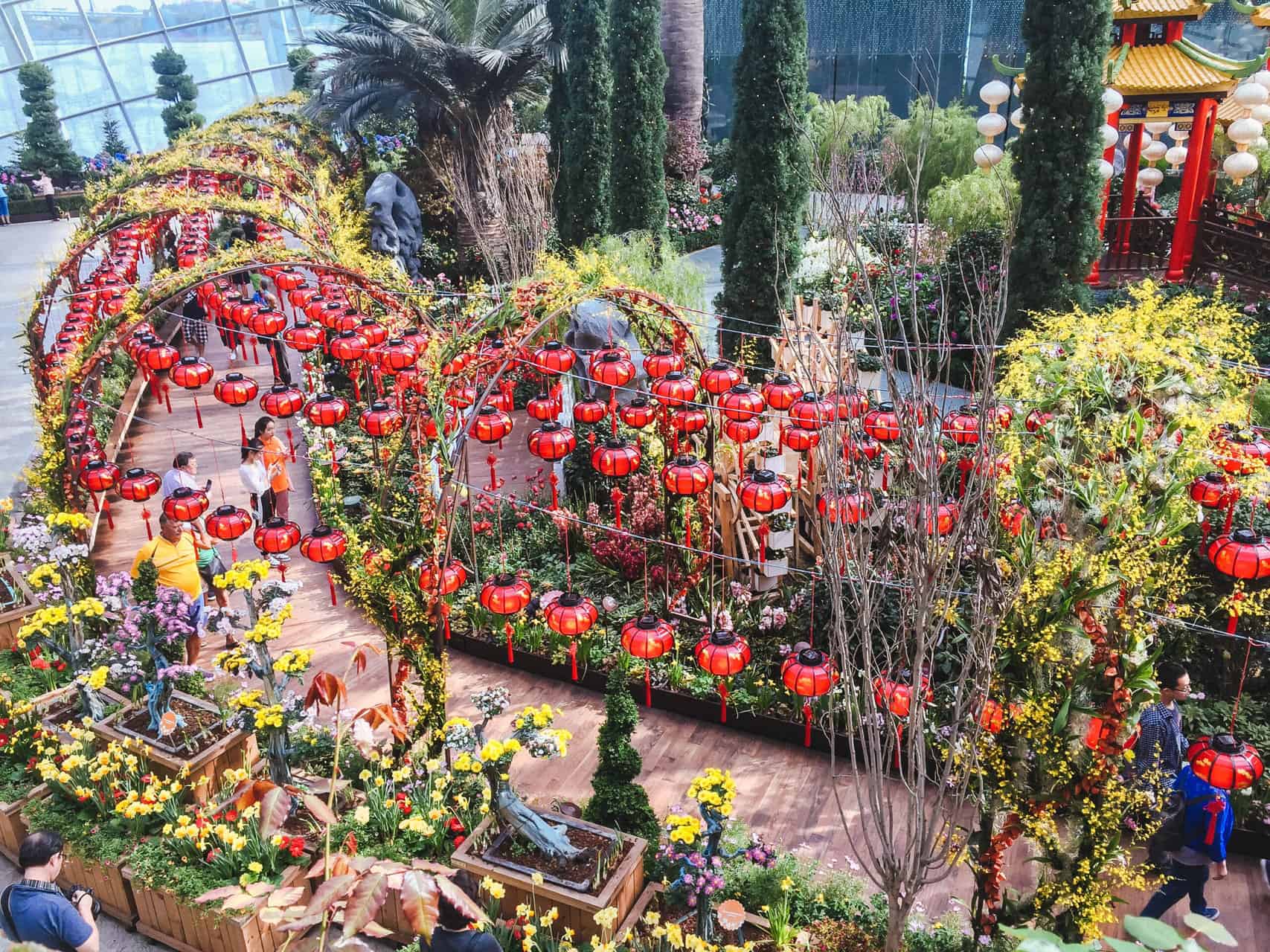 A row of lanterns and manicured gardens at Flower Dome at Gardens by the Bay, Singapore