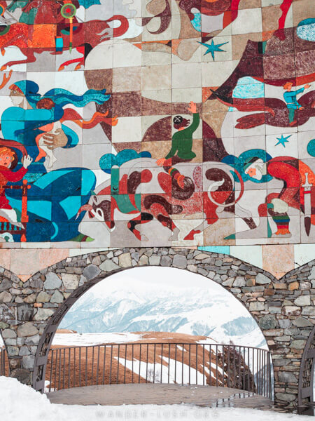 A colourful mosaic and a stone archway at Gudauri, Georgia.