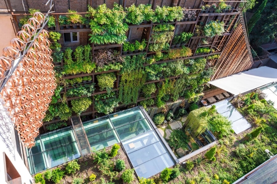 A hotel in Tbilisi with an internal courtyard and green walls.