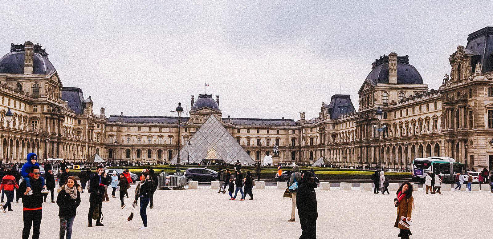 Outside of the Louvre with the glass pyramid in Paris, France