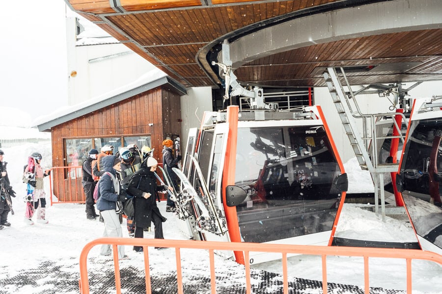 Passengers and skiers board the Kobi Gudauri cable car in Georgia.