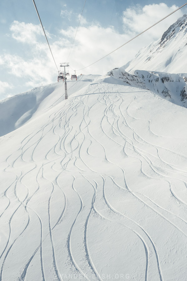 Off-piste ski tracks in the snow, as seen from the Kobi Gudauri cable car.