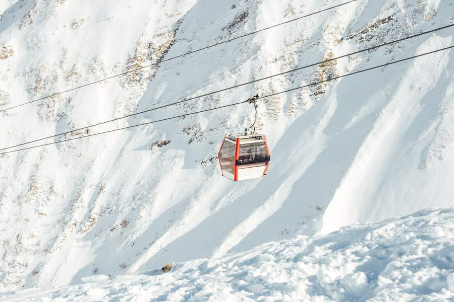 A lone French gondola against a backdrop of mountains at the Gudauri Ski Resort in Georgia.