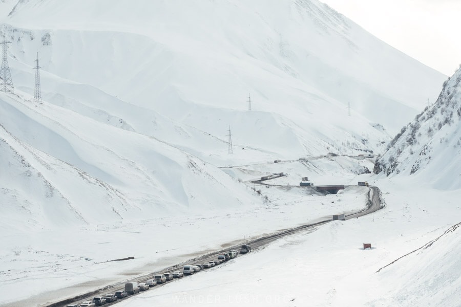 A winding snowy road through the Greater Caucasus mountains north of Tbilisi, Georgia.