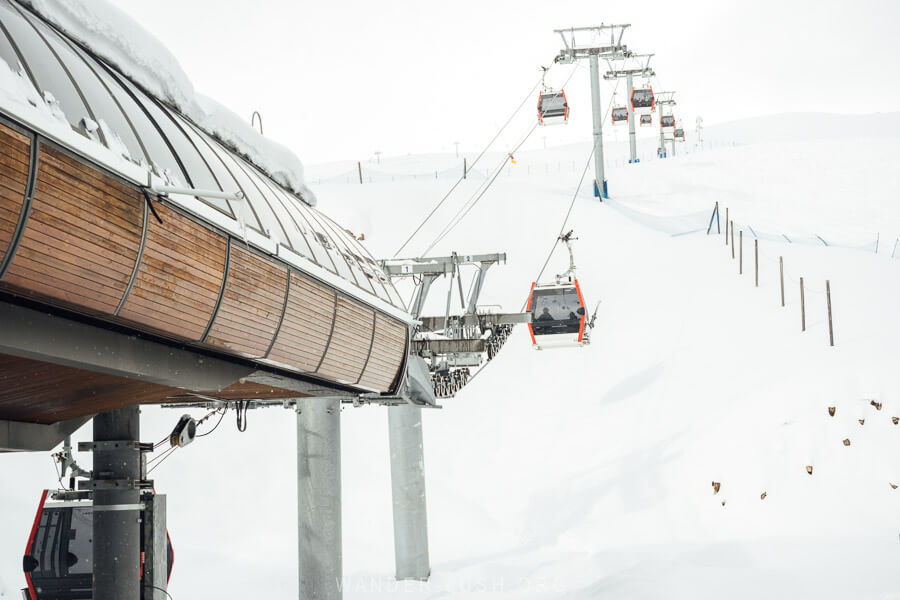 The Gudauri cable car bottom station, with gondolas stretching up into the high mountains.