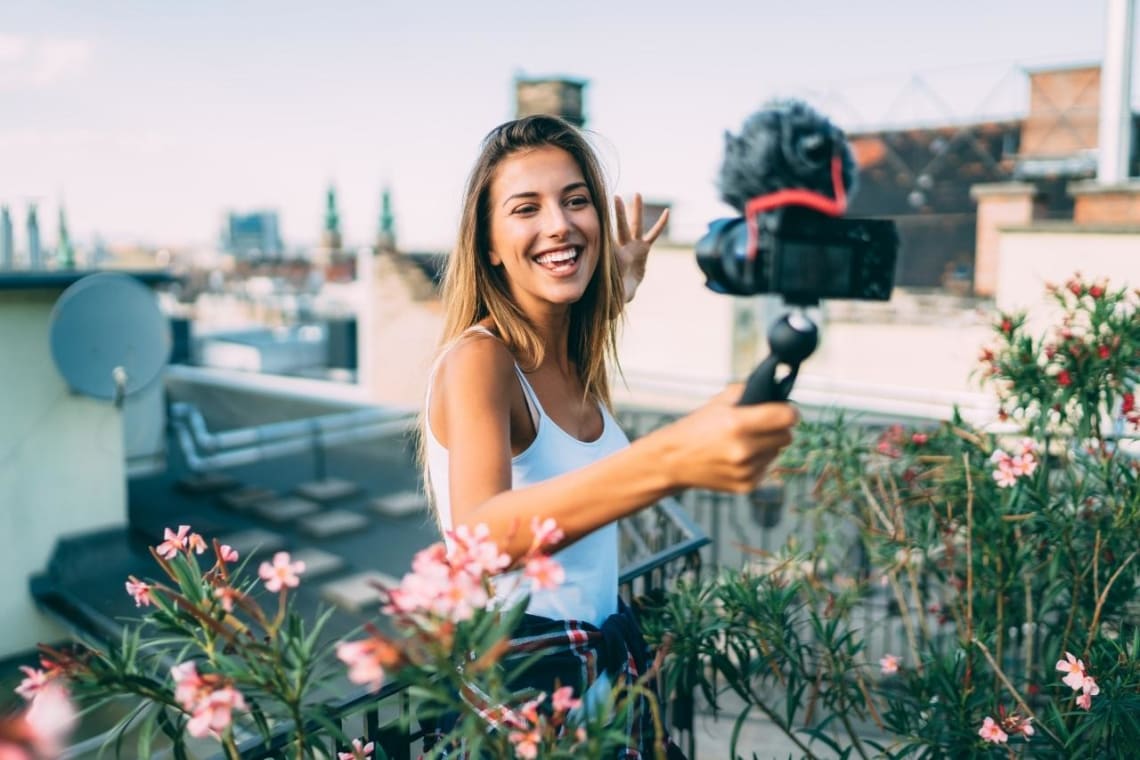 Digital nomad filming herself with a camera and mic