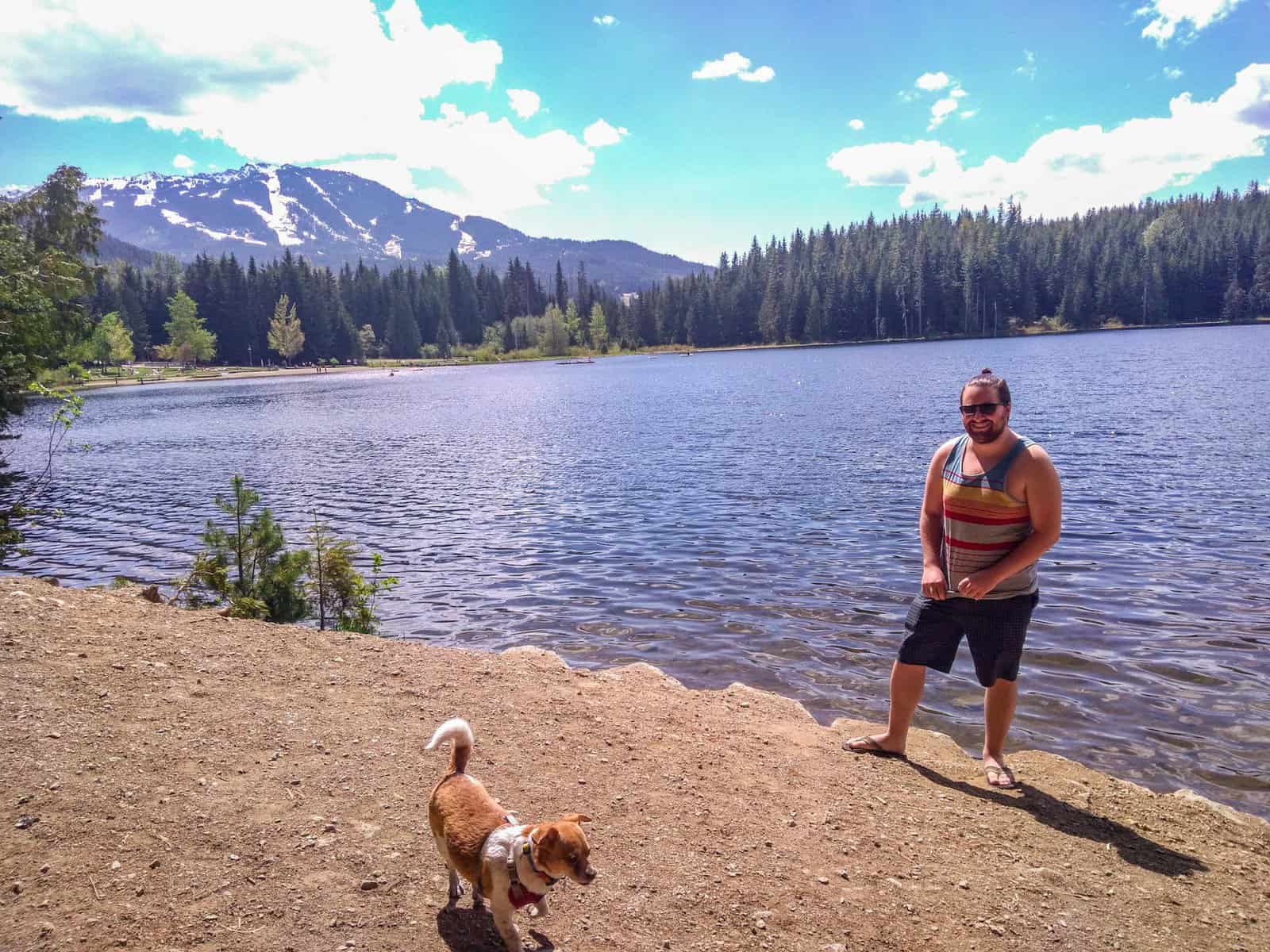 Colin posing at Lost Lake in Whistler with our dog, Ellie, on the shore