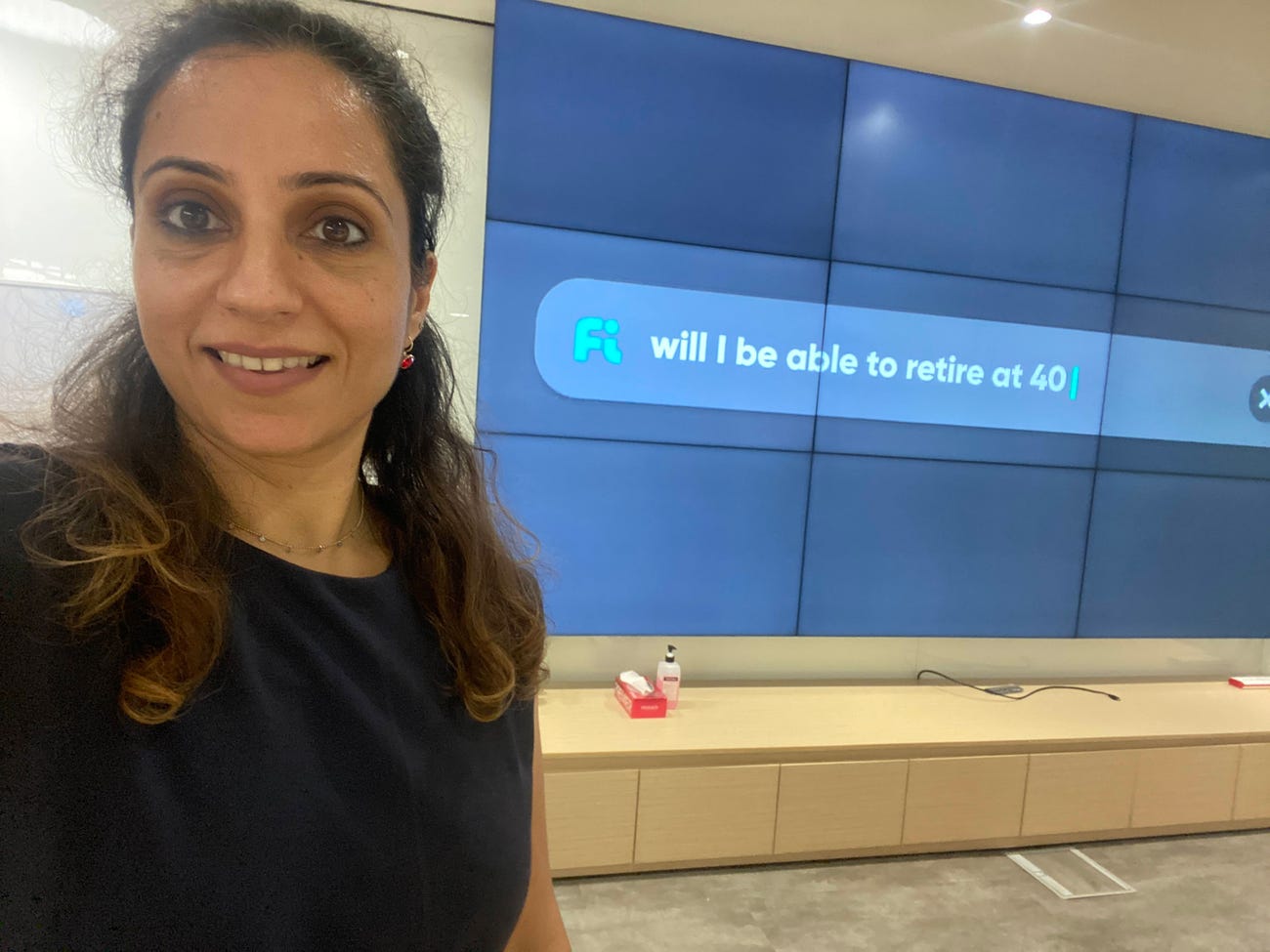 Woman standing in front of a financial services advertisement.