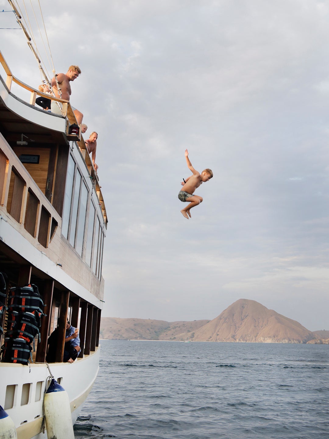 boy jumping off boat