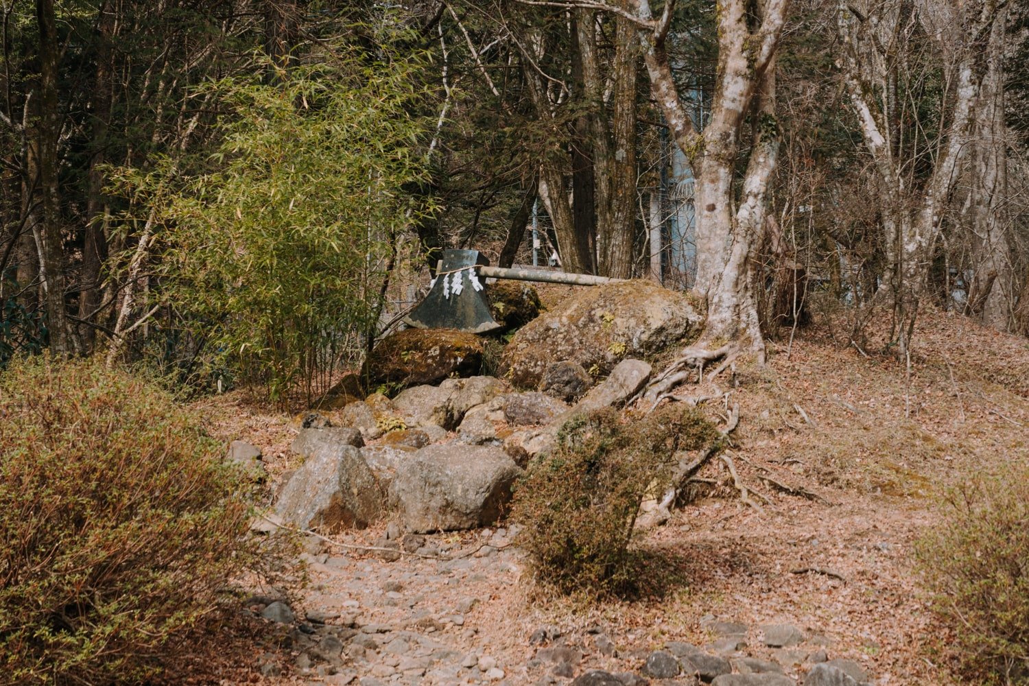 A large and legendary axe resting on rocks near the Kintoki Shrine, referring to the "Golden Boy" Kintaro, a Japanese folktale warrior.