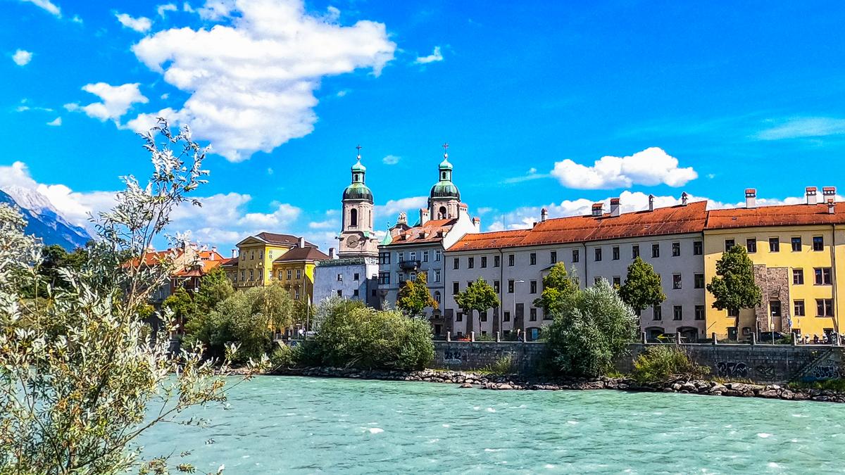 Historic Innsbruck Cathedral and River Inn with Alpine backdrop