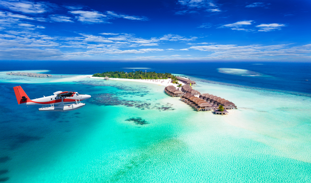 Aerial view of a seaplane approaching island in the Maldives