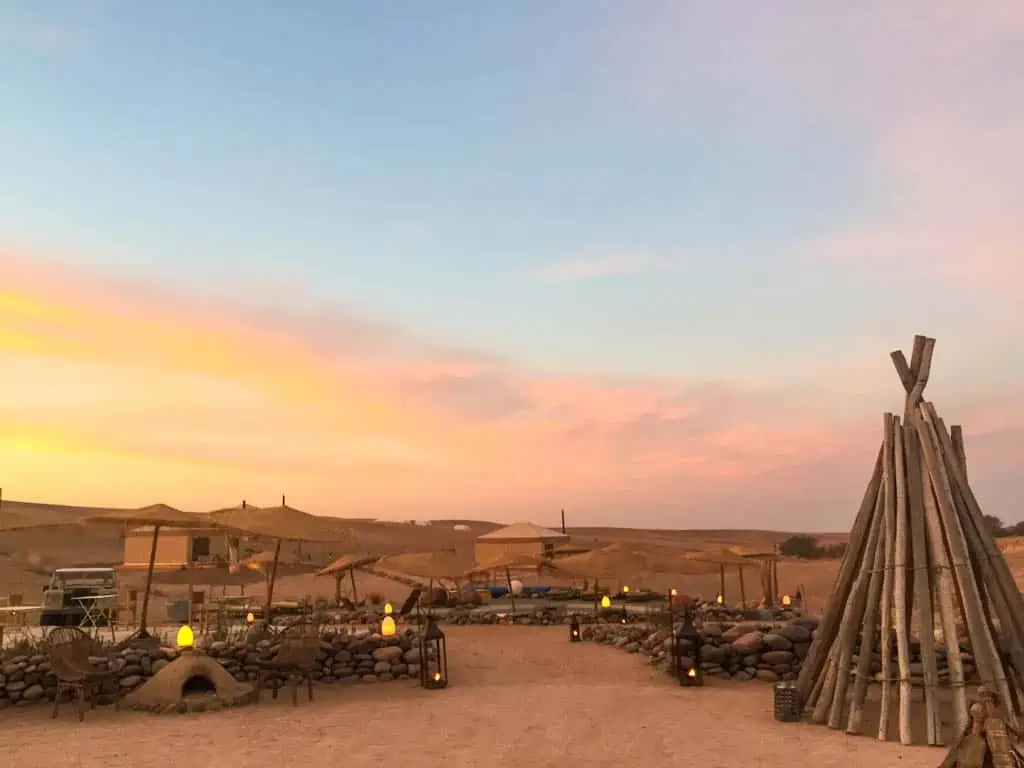 The sun starting to set over Inara Camp in the Agafay Desert Morocco