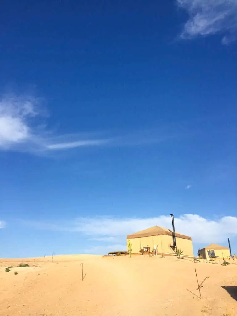 Agafay Desert in Morocco with bright blue sky, sand and a glamping tent