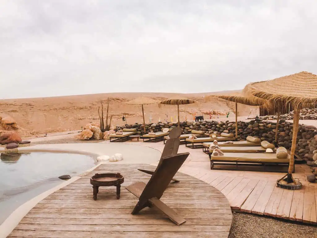 The outdoor pool with lounge chairs around it at Inara Camp in the Agafay Desert, Morocco 