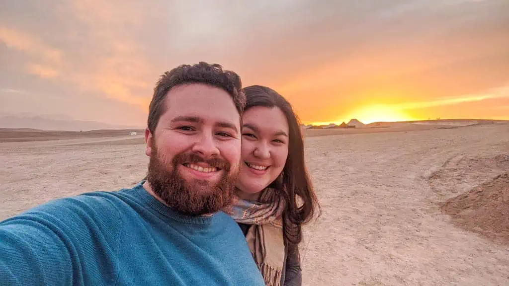 Colin and Riana taking a selfie with the sunset in the Agafay Desert, Morocco