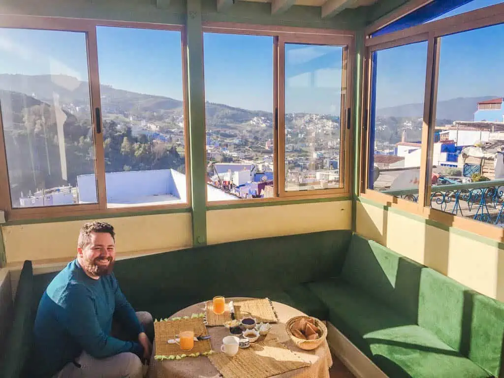 Colin eating breakfast on the rooftop at Hotel Honeysuckle riad in Chefchaouen, Morocco