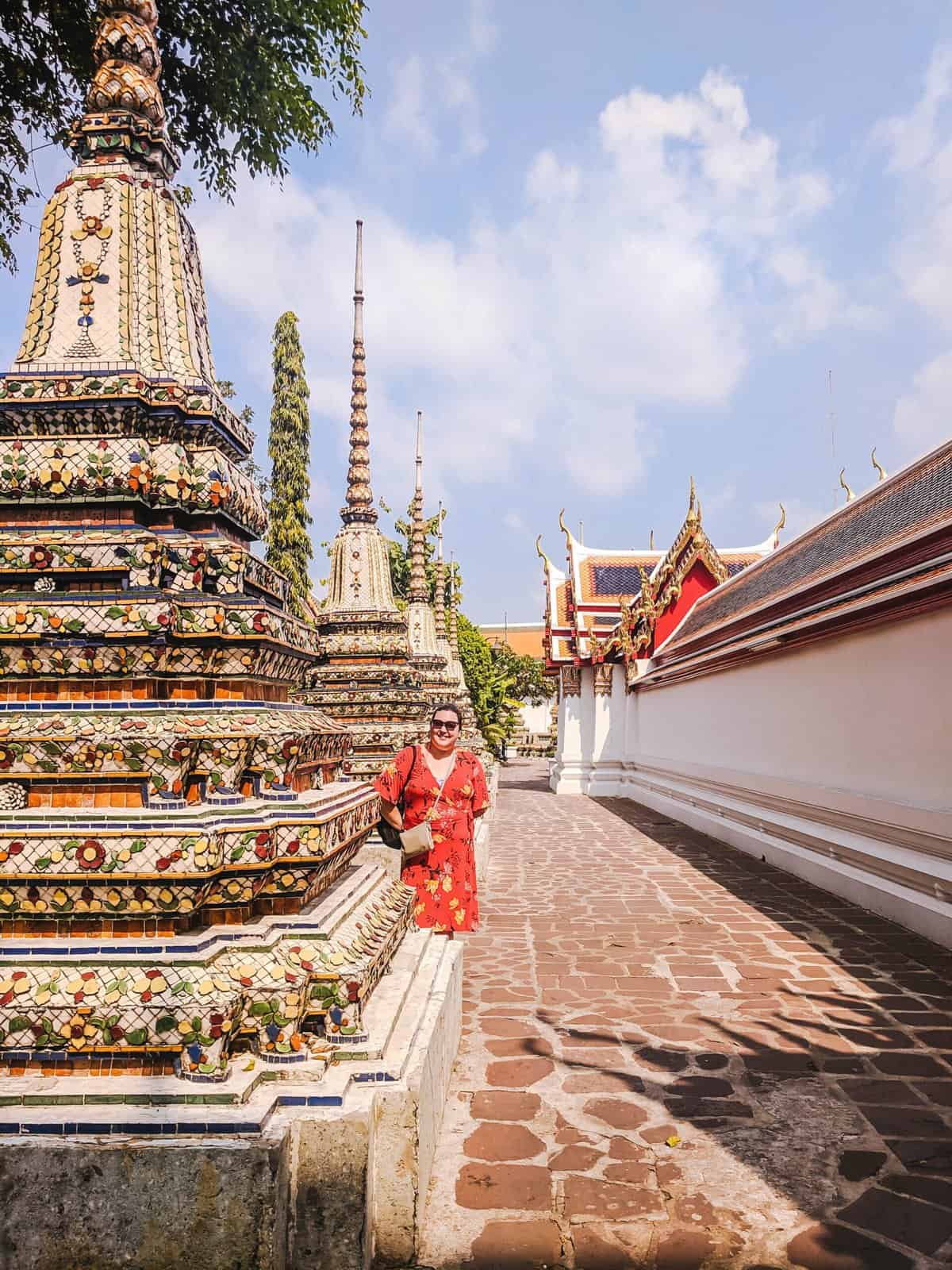 Riana posing in front of temples in Bangkok, Thailand