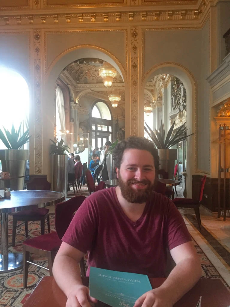 Colin seated in the ugly room at the new york cafe, new york cafe photos, budapest hungary