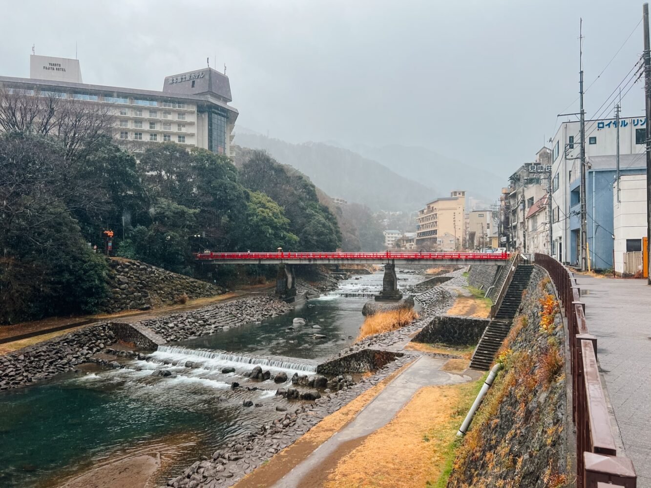 Hakone-Yumoto river and red bridge under the rain.