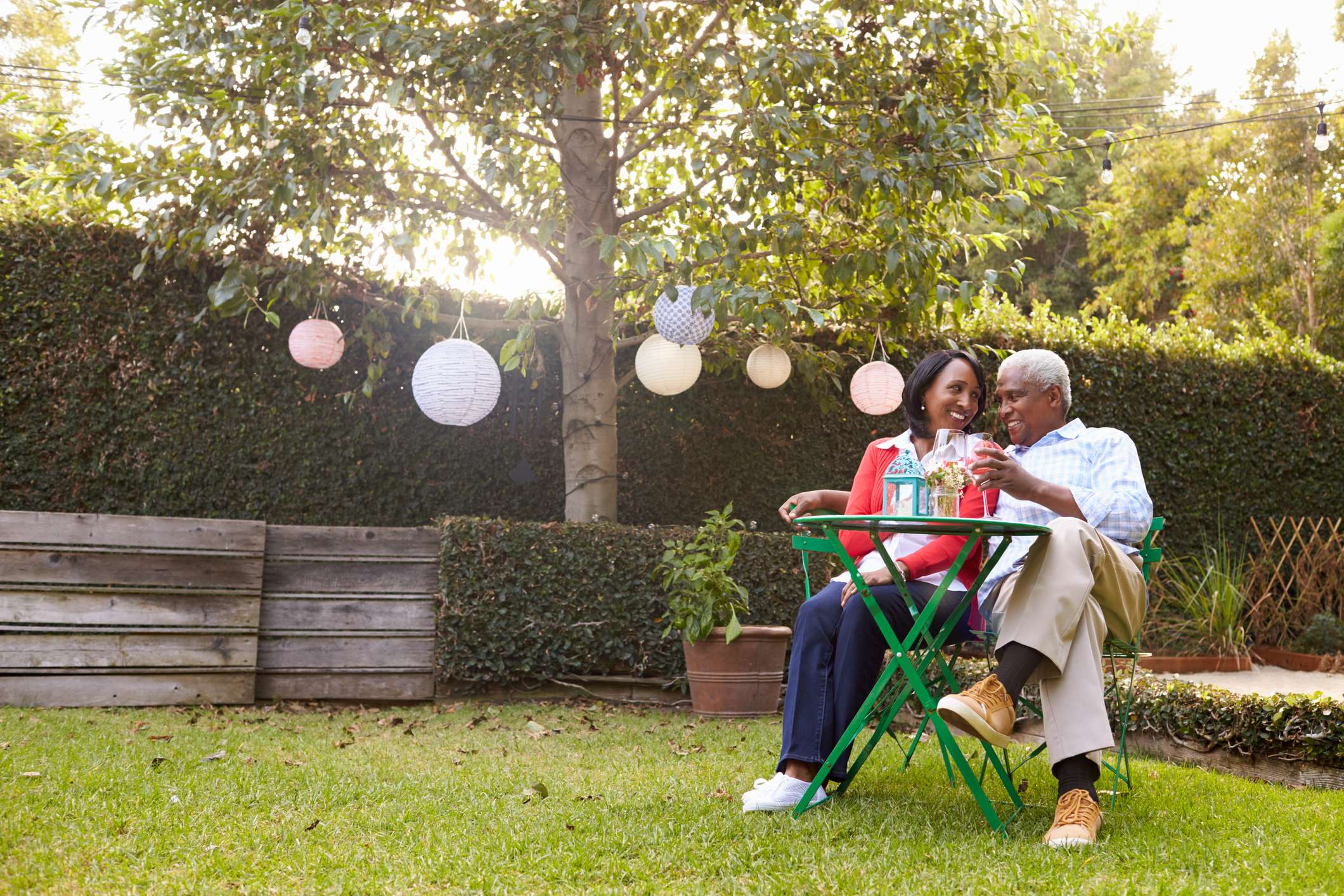 Smiling couple sitting in backyard.